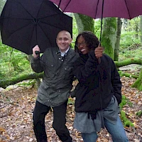 Mann und Frau mit Regenschirm im Wald