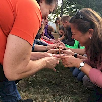 Mit den Fingern gemeinsam Stange halten
